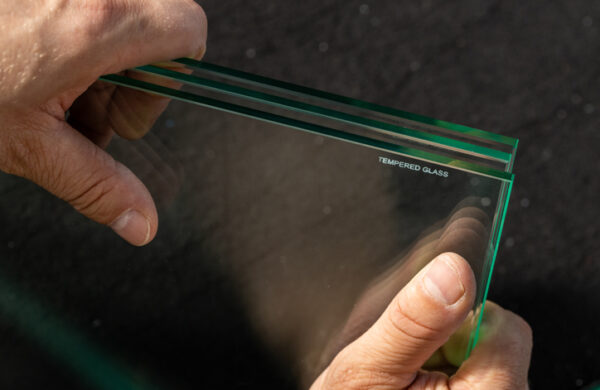 man holds tempered glass in his hands